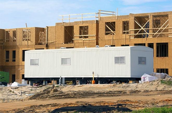 crane lifting modular building for construction office rentals in Blue Jay, CA